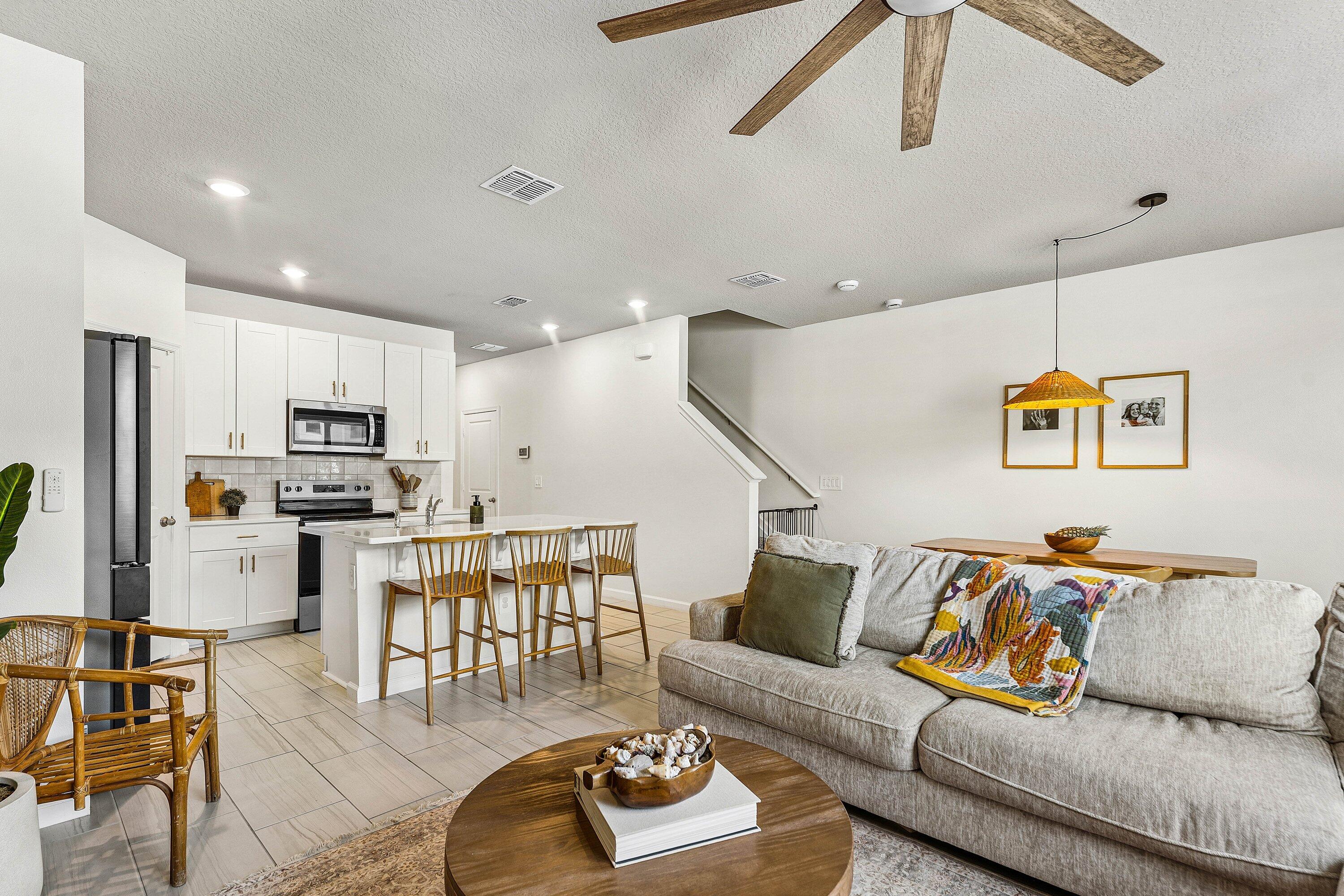 5739 Southeast Edgewater Circle Stuart, FL 34997 - Photo 10 of 29 a living room with furniture kitchen view and a wooden floor