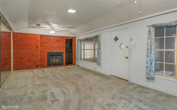 an empty room with furniture and a fireplace
