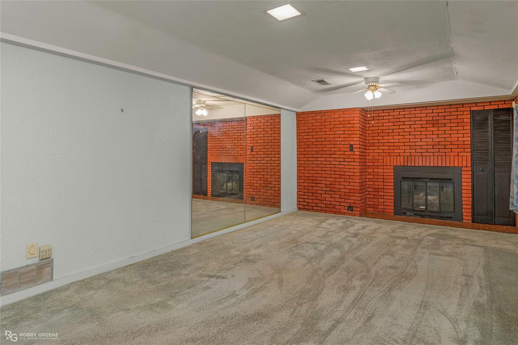 302 Princeton Road Princeton, LA 71067 - Photo 12 of 33 an empty room with furniture and a fireplace