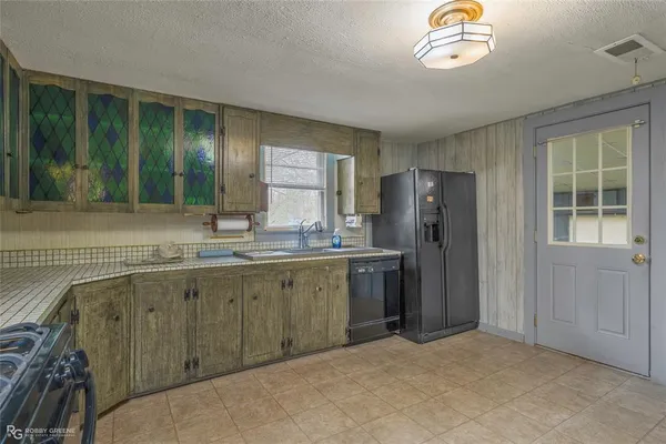 a kitchen with stainless steel appliances a stove sink and refrigerator