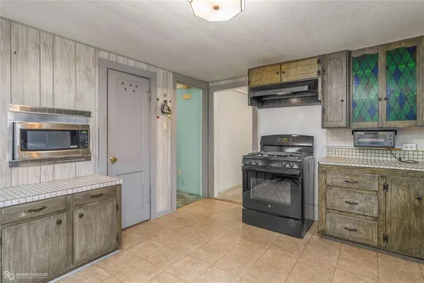 a room with window and white cabinets