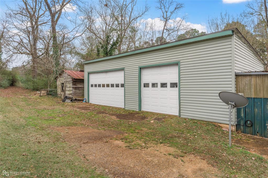 302 Princeton Road Princeton, LA 71067 - Photo 30 of 33 a view of a white house next to a yard and garage