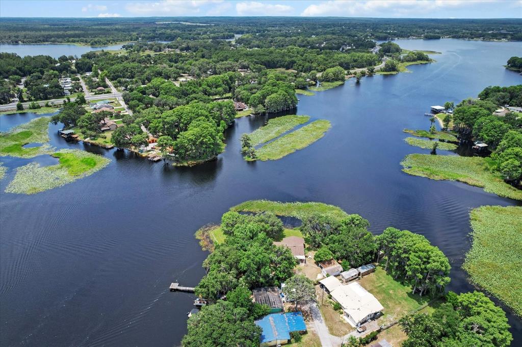 1226 South Telephone Point Road Inverness, FL 34450 - Photo 5 of 43 an aerial view of a house with a yard and lake view