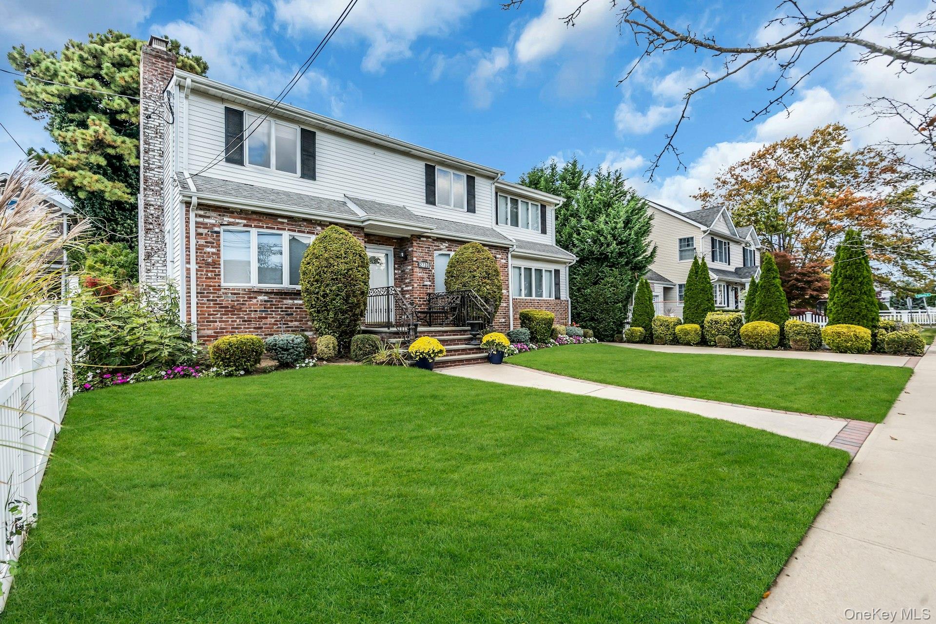 2730 Remsen Street Baldwin, NY 11510 - Photo 2 of 31 Traditional home featuring brick siding, a chimney, and a front yard
