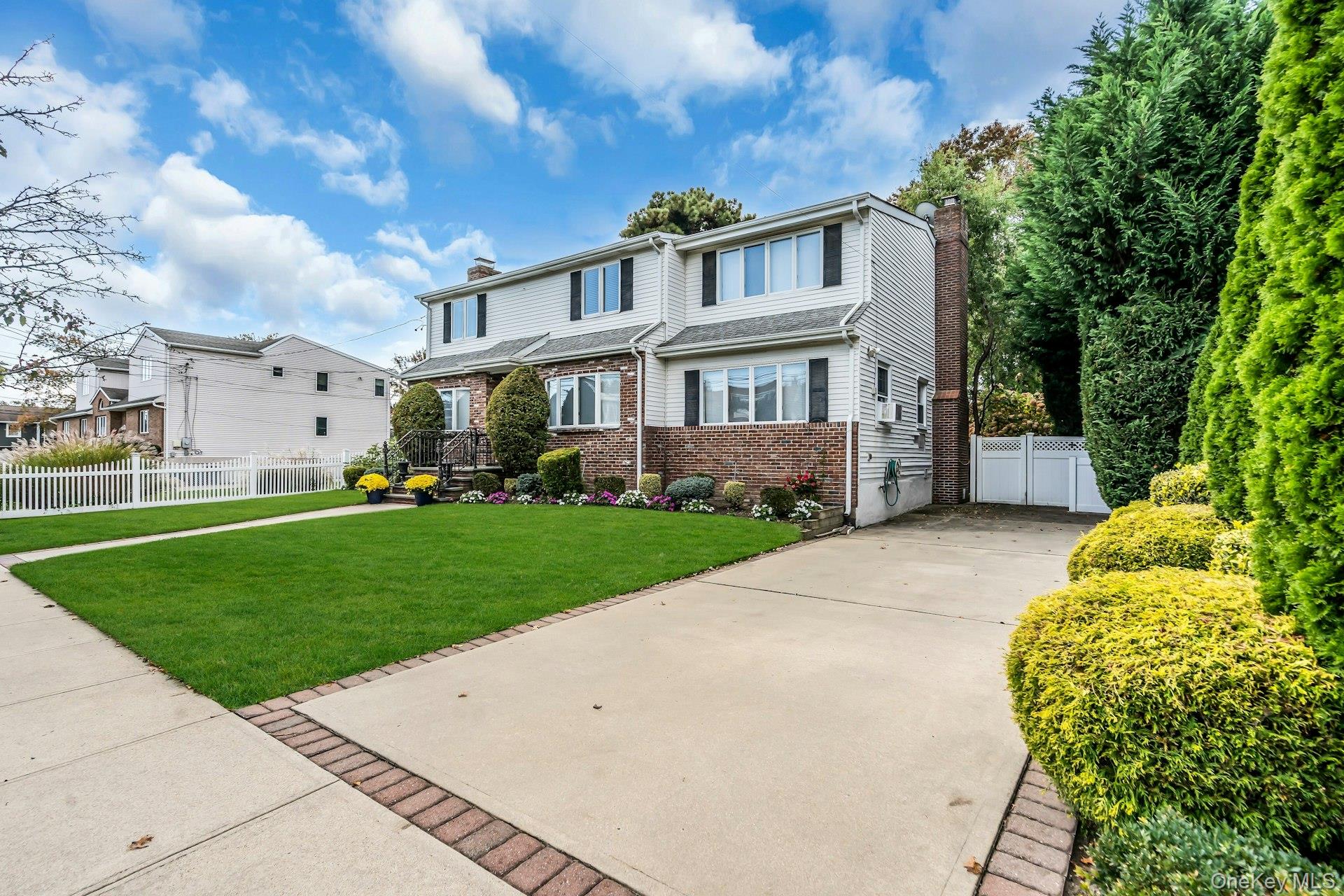 2730 Remsen Street Baldwin, NY 11510 - Photo 29 of 31 View of front of property featuring a chimney, brick siding, and concrete driveway