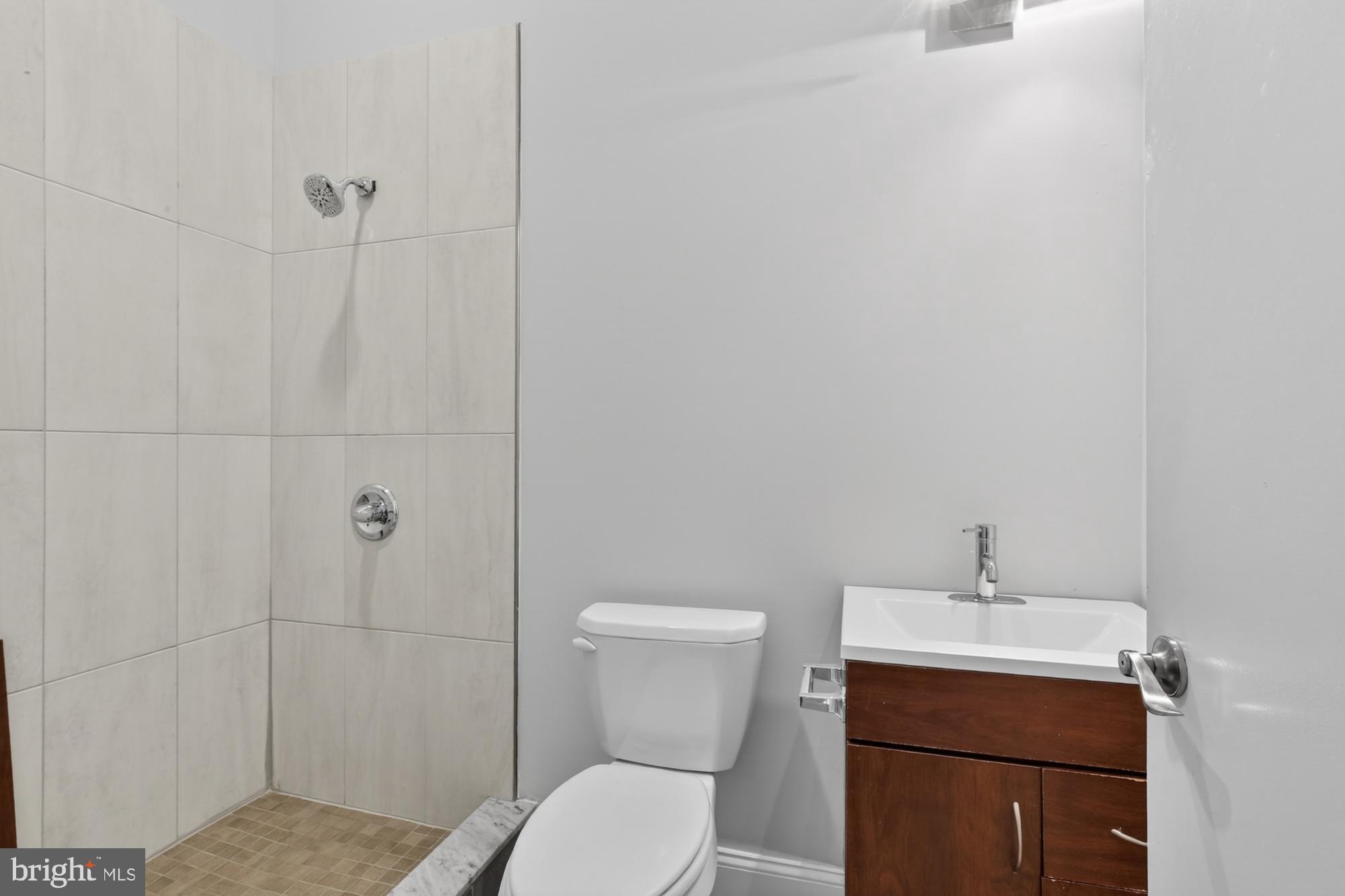 2136 East Dauphin Street, Unit 101 Philadelphia, PA 19125 - Photo 21 of 30 a bathroom with a toilet sink and shower