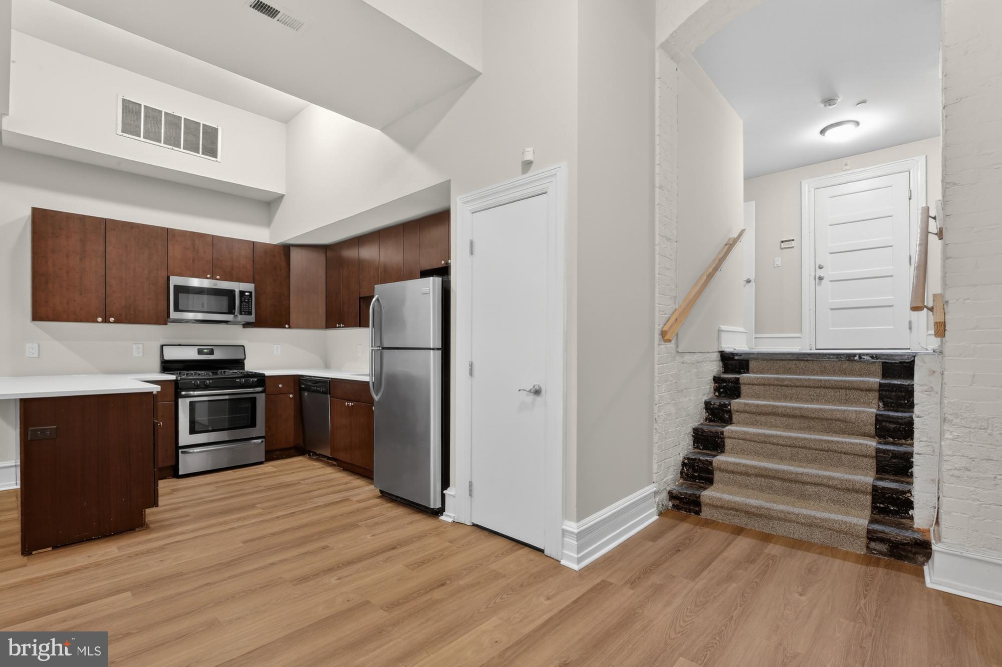 2136 East Dauphin Street, Unit 101 Philadelphia, PA 19125 - Photo 3 of 30 a kitchen with granite countertop a refrigerator and a sink