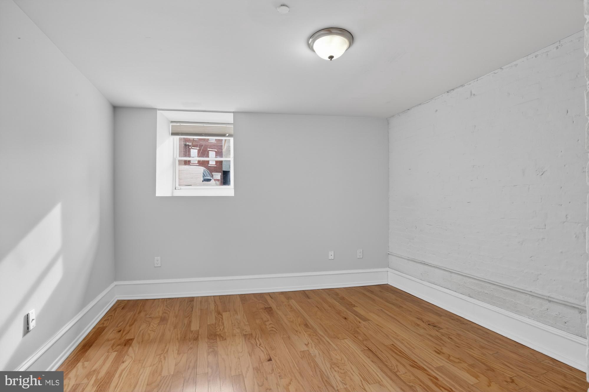 2136 East Dauphin Street, Unit 101 Philadelphia, PA 19125 - Photo 5 of 30 wooden floor in an empty room with a window