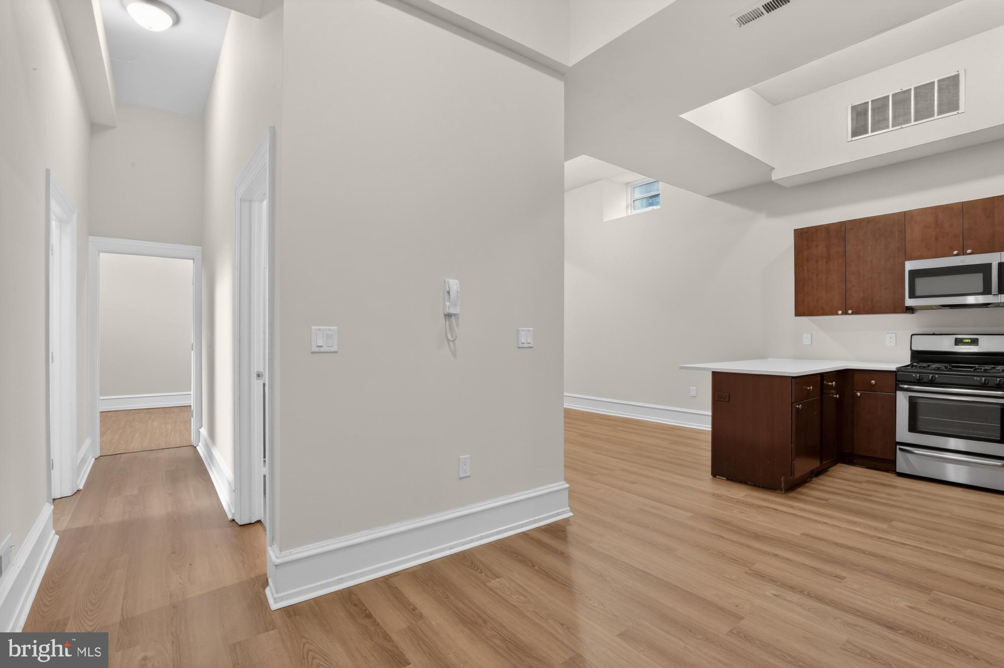 2136 East Dauphin Street, Unit 101 Philadelphia, PA 19125 - Photo 10 of 30 a room with wooden floor and electronic appliances