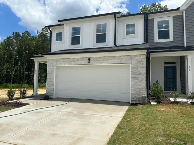 a view of a house with backyard and porch