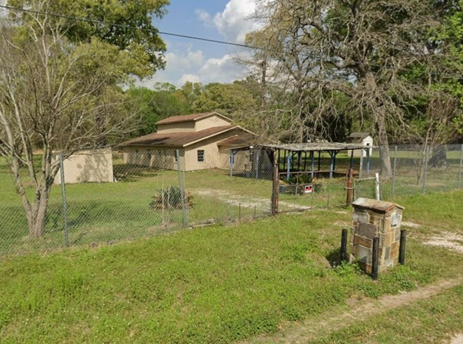 18357 Pickering Road Conroe, TX 77302 - Photo 4 of 5 a view of a house with a yard