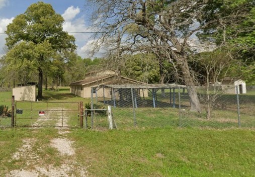 18357 Pickering Road Conroe, TX 77302 - Photo 5 of 5 a backyard of a house with table and chairs