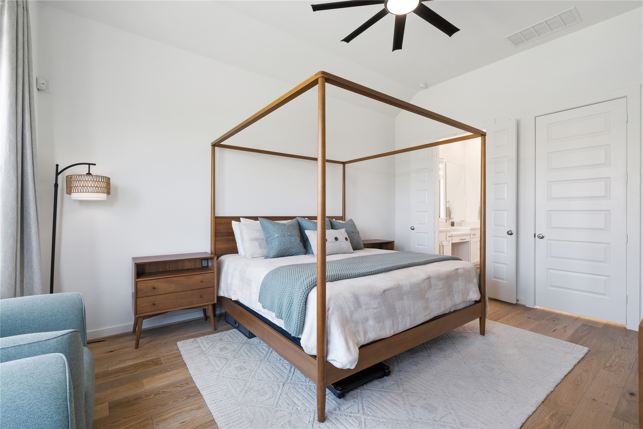 416 Bartlett Street Webster, TX 77598 - Photo 23 of 49 Primary bedroom with four-poster canopy bed and en suite bath entry