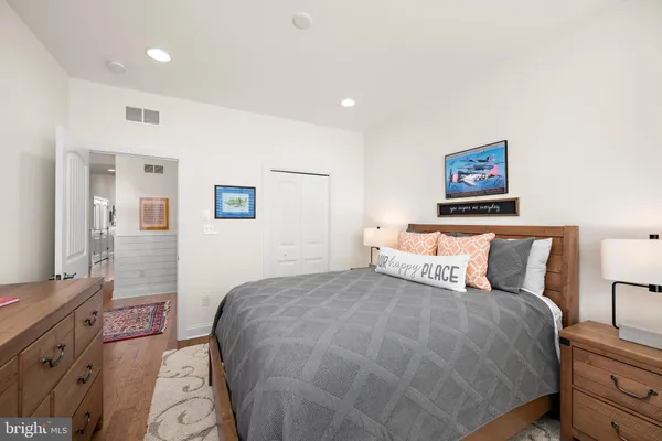 a bedroom with a bed and a painting on the wall