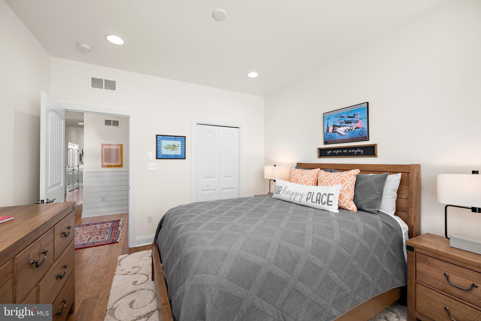 11119 Marvil Road, Unit 93 Lewes, DE 19958 - Photo 16 of 52 a bedroom with a bed and a painting on the wall