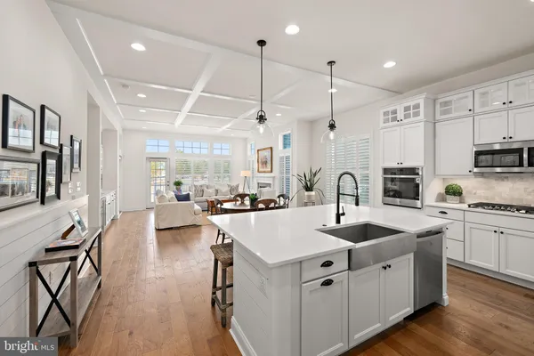 a kitchen with stainless steel appliances granite countertop a sink refrigerator and cabinets