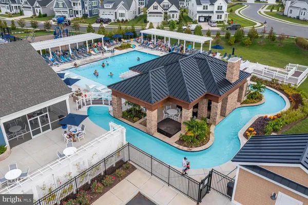 an aerial view of a house with swimming pool outdoor seating