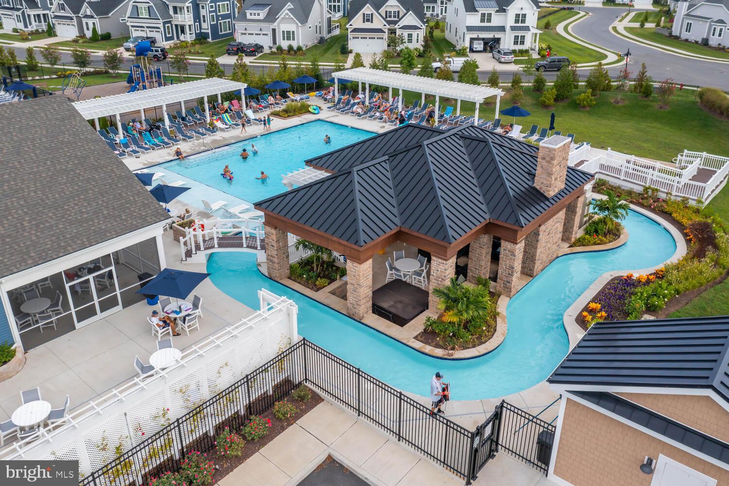 11119 Marvil Road, Unit 93 Lewes, DE 19958 - Photo 2 of 52 an aerial view of a house with swimming pool outdoor seating