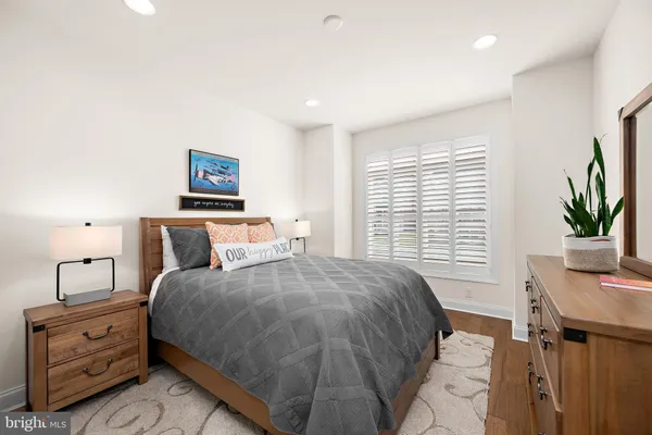 a bedroom with a bed and a potted plant