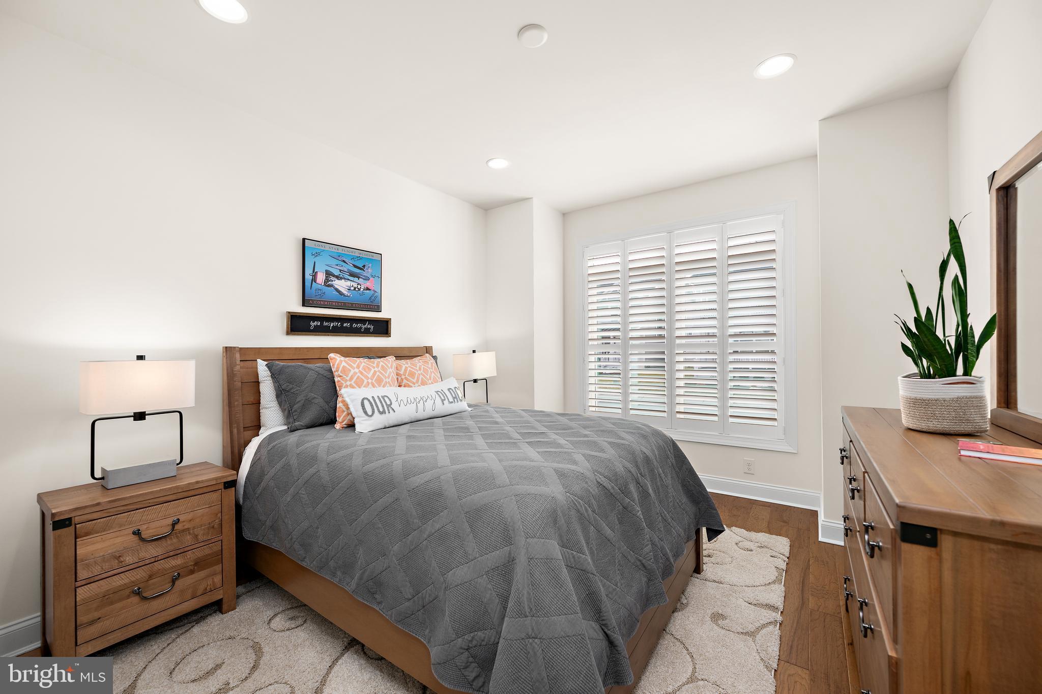 11119 Marvil Road, Unit 93 Lewes, DE 19958 - Photo 27 of 52 a bedroom with a bed and a potted plant