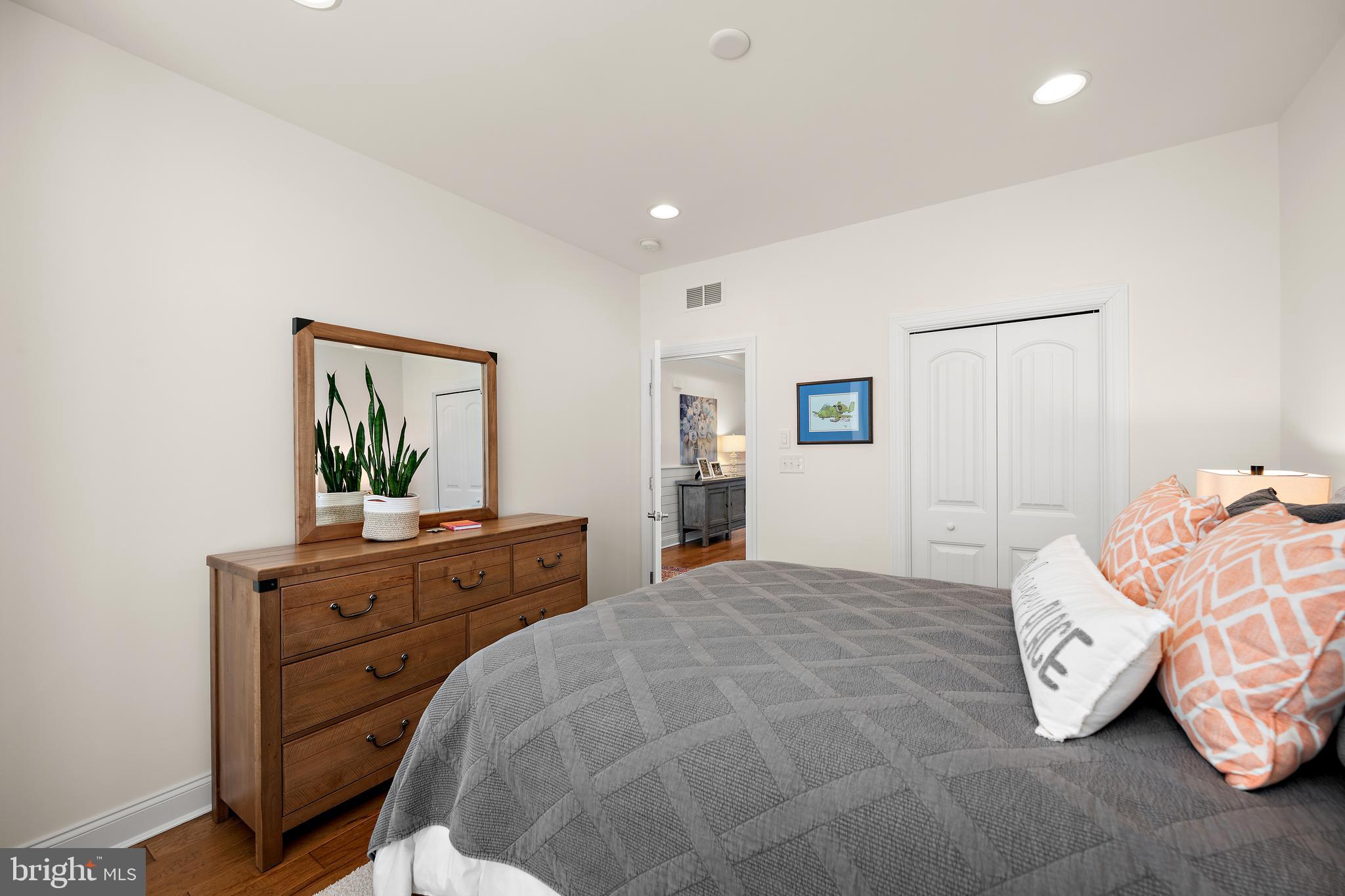 11119 Marvil Road, Unit 93 Lewes, DE 19958 - Photo 28 of 52 a bedroom with a bed and a dresser