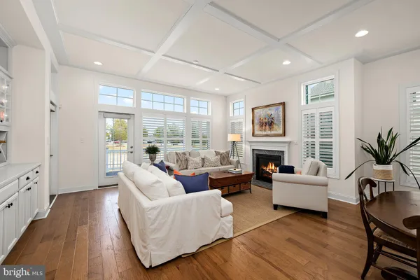 a living room with fireplace furniture and a large window