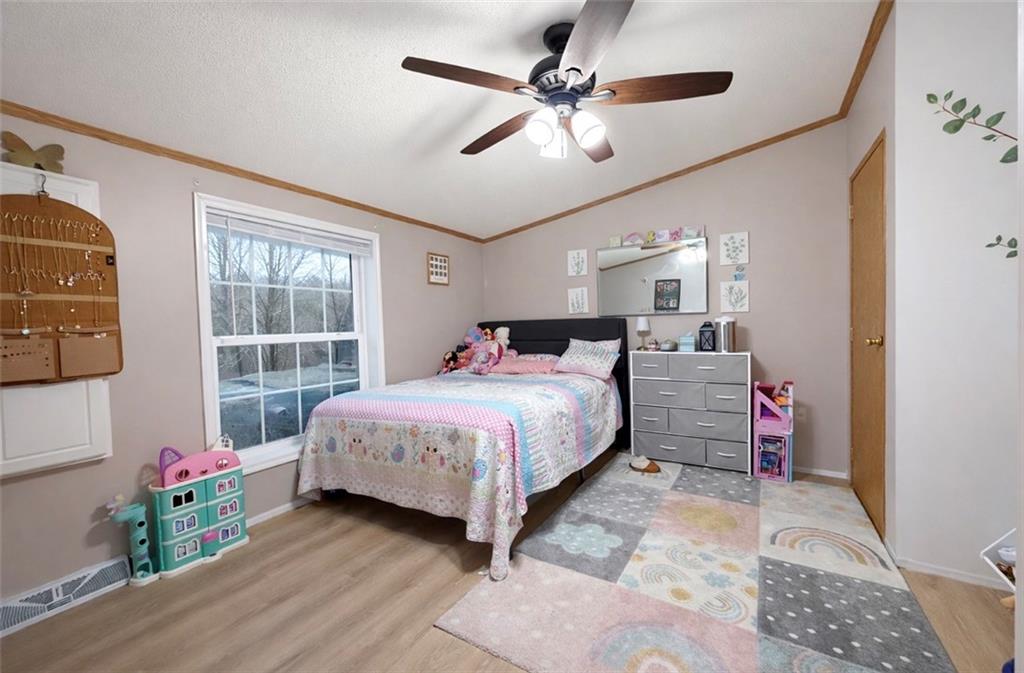 180 Hemlock Road Petrolia, PA 16050 - Photo 12 of 25 a bedroom with a bed chandelier and a window