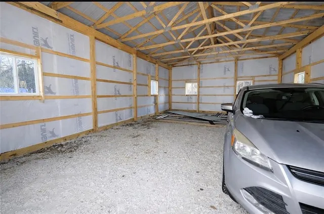 a view of a garage room with wooden floor