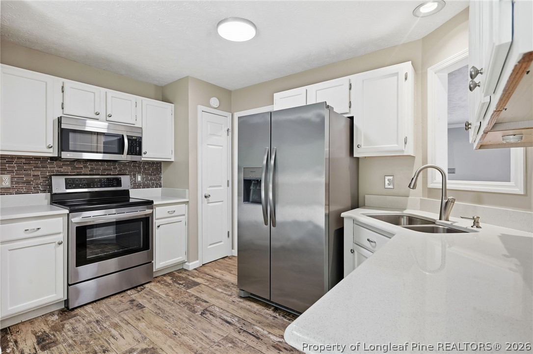 5113 Archer Road Hope Mills, NC 28348 - Photo 18 of 41 a kitchen with stainless steel appliances granite countertop a refrigerator a stove and a sink