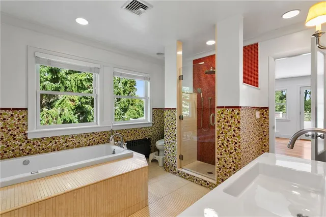 a spacious bathroom with a bathtub and shower