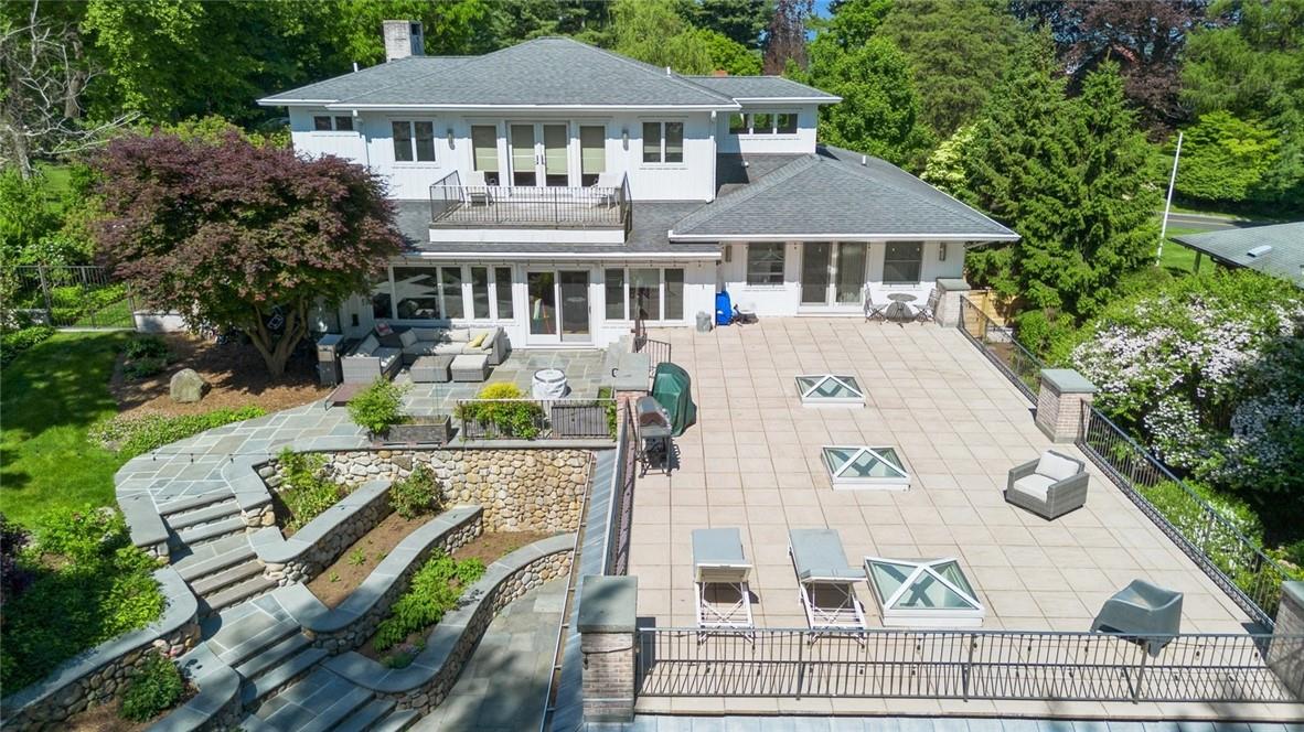 177 Clinton Avenue Dobbs Ferry, NY 10522 - Photo 2 of 29 a view of a white house with a chairs in patio