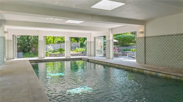 a large swimming pool is sitting in the middle of a house