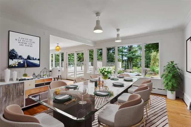 a room with furniture lots of windows and wooden floor