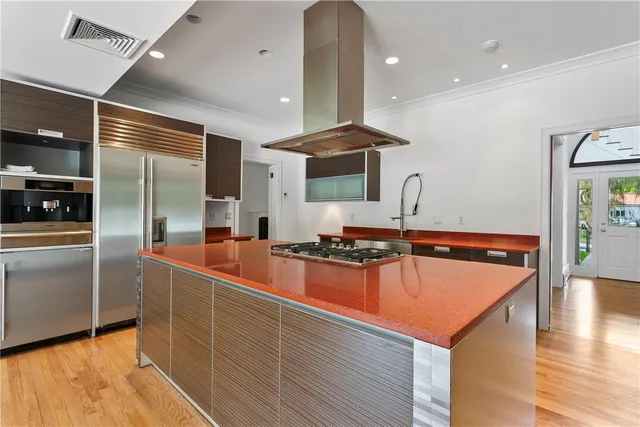a kitchen with stainless steel appliances granite countertop a sink and a refrigerator