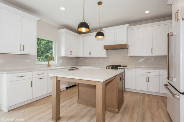 a kitchen with a stove window and cabinets