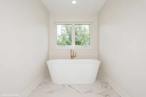 a white bath tub sitting in a bathroom