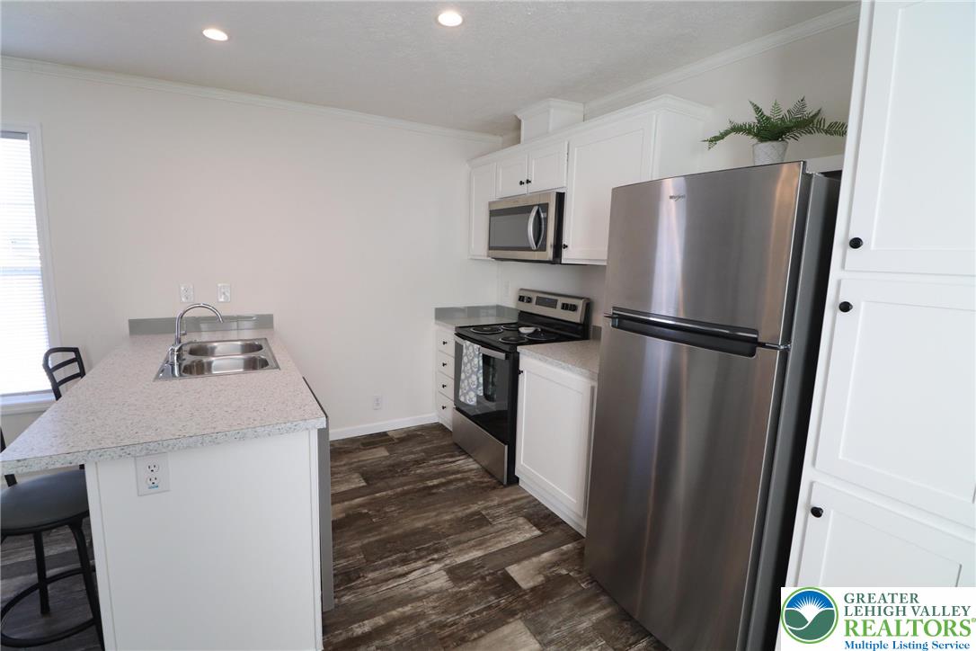 5016 Old Timber Road Stroudsburg, PA 18360 - Photo 11 of 34 a kitchen with a refrigerator and a stove
