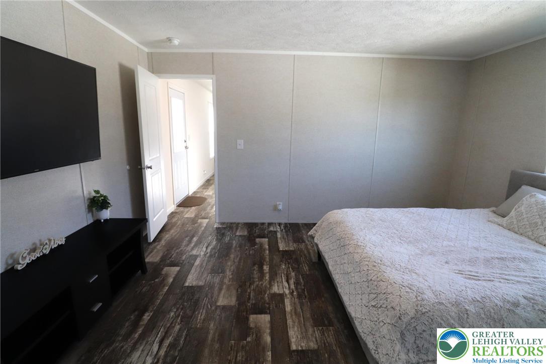 5016 Old Timber Road Stroudsburg, PA 18360 - Photo 15 of 34 a bedroom with a bed and a flat tv screen on the dresser