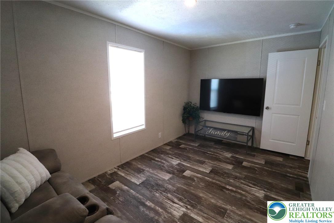 5016 Old Timber Road Stroudsburg, PA 18360 - Photo 25 of 34 a living room with furniture and a flat screen tv