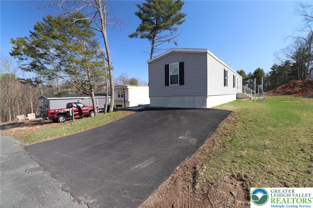 5016 Old Timber Road Stroudsburg, PA 18360 - Photo 34 of 34 a front view of a house with a yard and garage