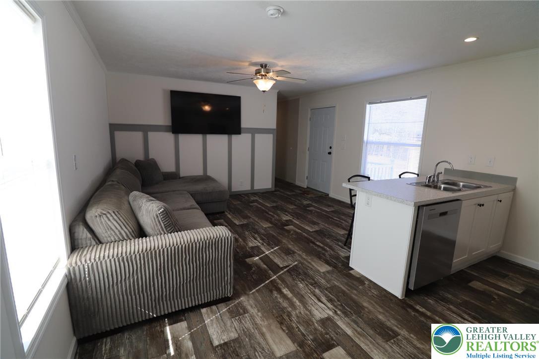 5016 Old Timber Road Stroudsburg, PA 18360 - Photo 5 of 34 a living room with furniture and a chandelier