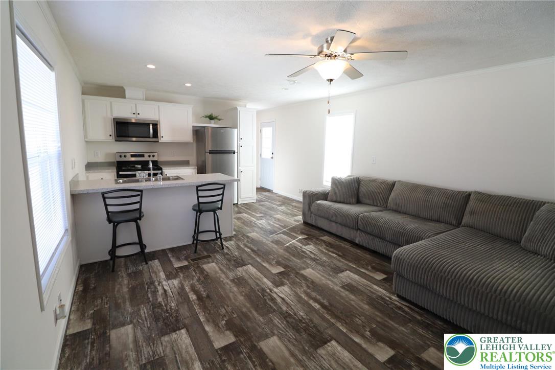 5016 Old Timber Road Stroudsburg, PA 18360 - Photo 7 of 34 a living room with furniture and a kitchen view