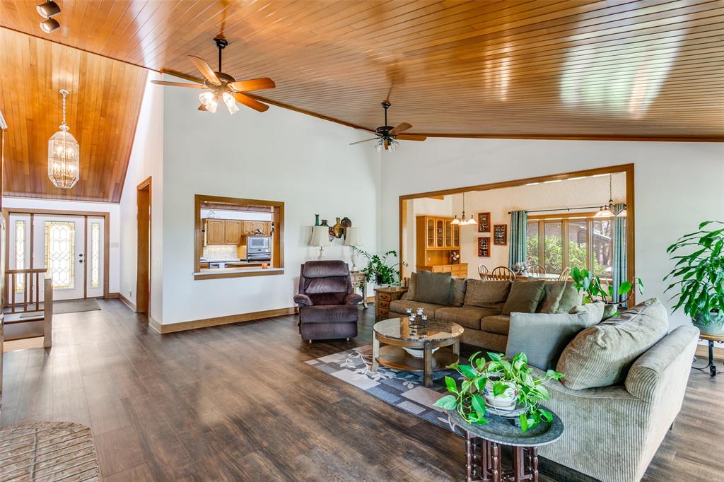 1557 Latigo Hills Road Bartonville, TX 75022 - Photo 5 of 40 Living room with suspended lighting, dark wood finished floors, a ceiling fan, and a vaulted wooden ceiling