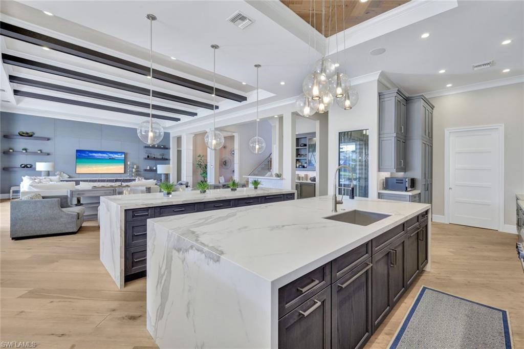 16988 Fairgrove Way Naples, FL 34110 - Photo 11 of 34 a kitchen with stainless steel appliances granite countertop a sink and a stove