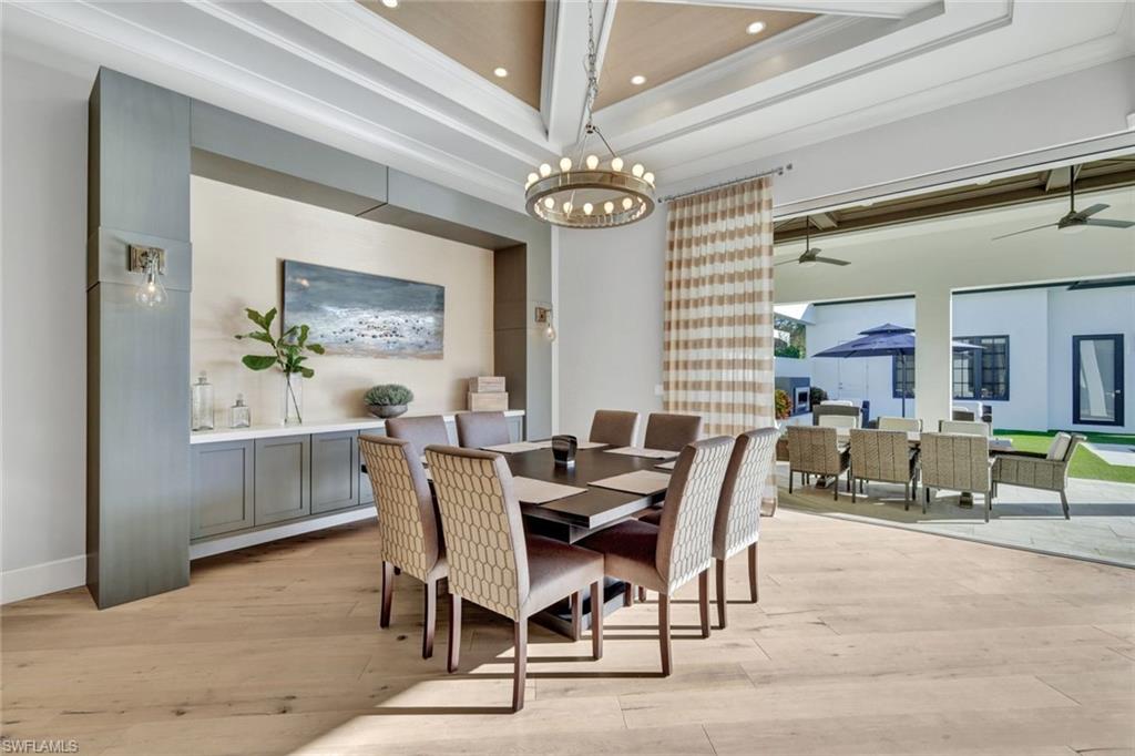 16988 Fairgrove Way Naples, FL 34110 - Photo 12 of 34 a view of a dining room with furniture and a chandelier
