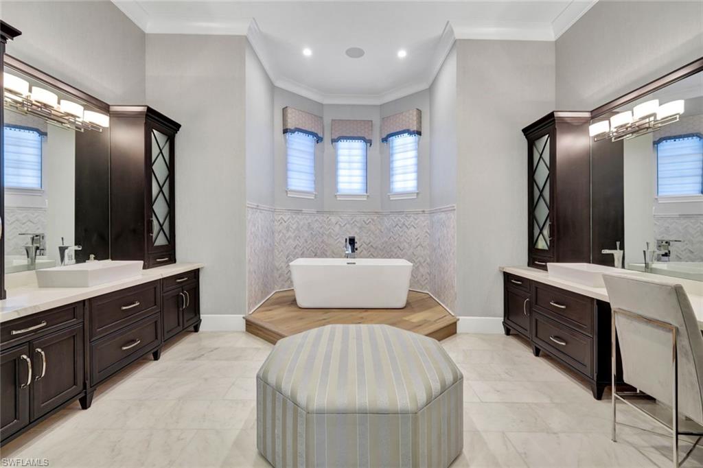16988 Fairgrove Way Naples, FL 34110 - Photo 15 of 34 a spacious bathroom with a double vanity sink double and mirror