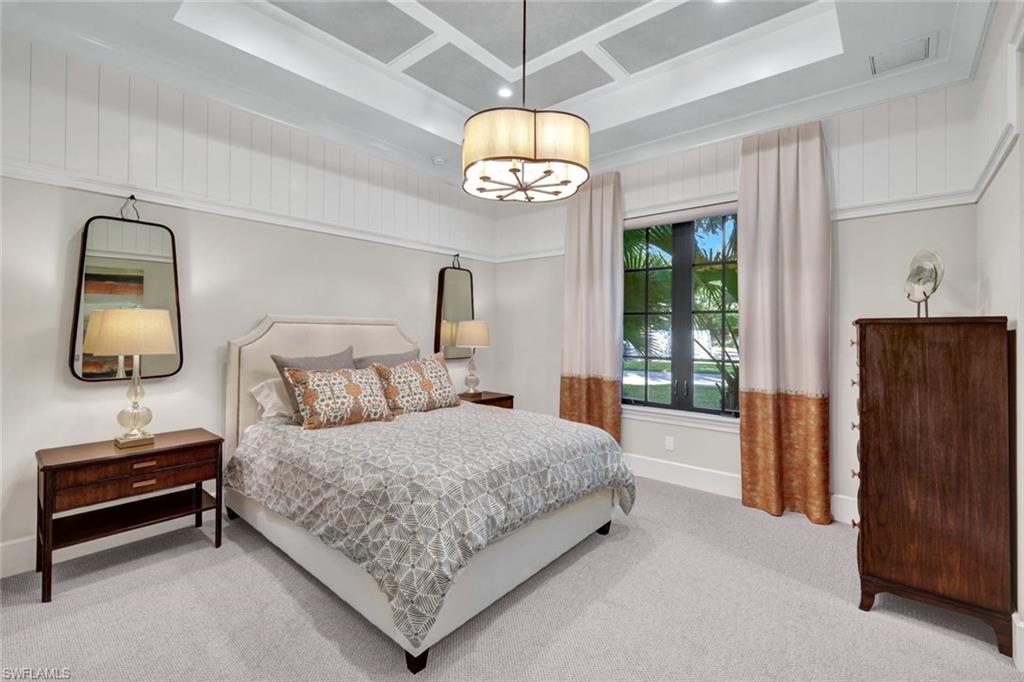 16988 Fairgrove Way Naples, FL 34110 - Photo 17 of 34 a bedroom with a bed and a window