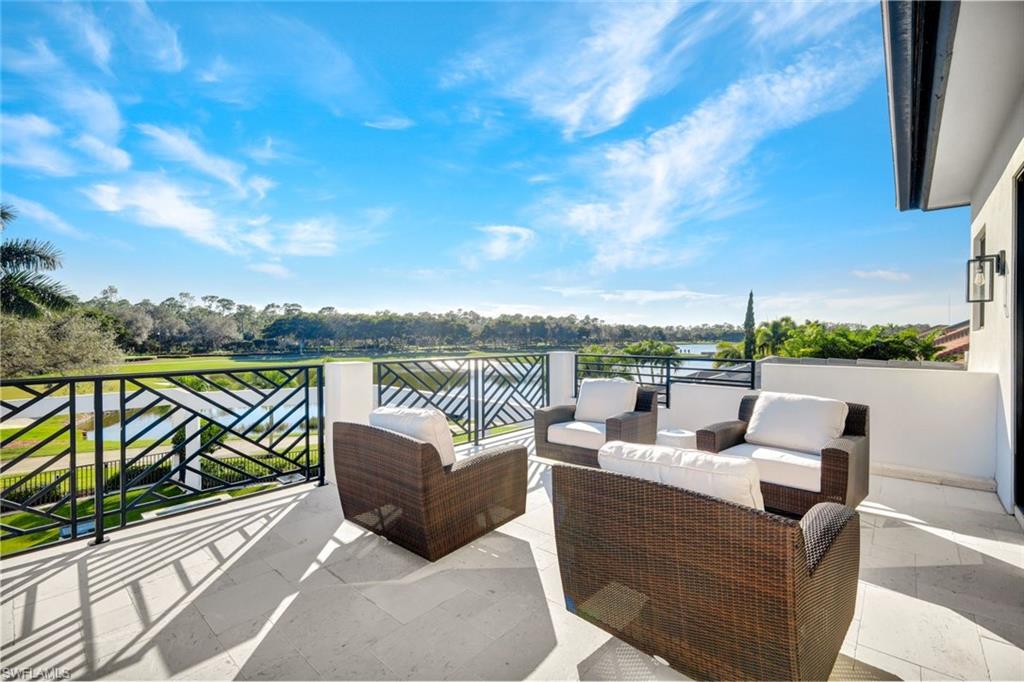 16988 Fairgrove Way Naples, FL 34110 - Photo 27 of 34 a view of a roof deck with couches and sky view