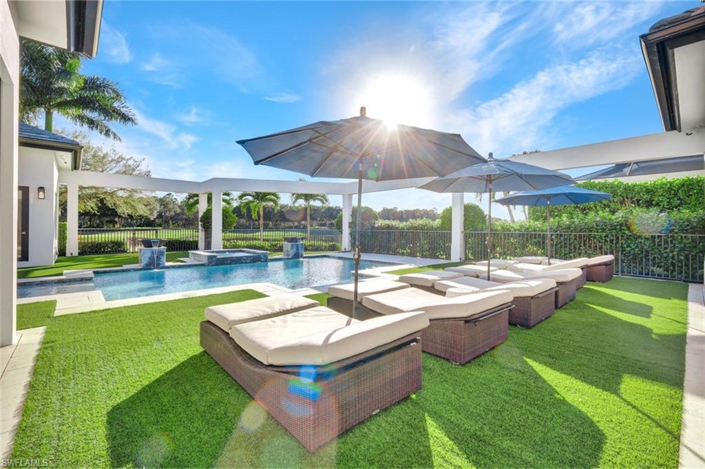 16988 Fairgrove Way Naples, FL 34110 - Photo 29 of 34 a view of a patio with chairs and a yard