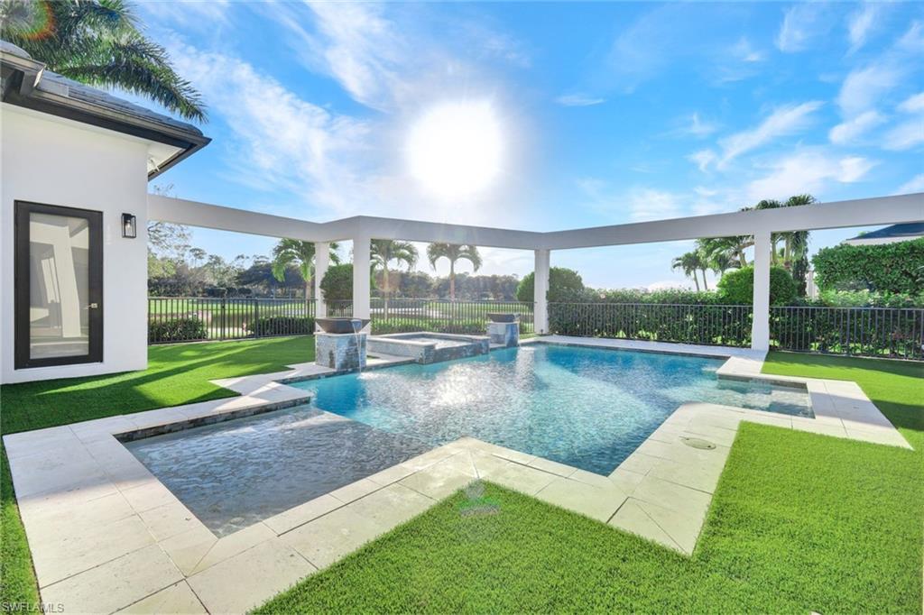16988 Fairgrove Way Naples, FL 34110 - Photo 32 of 34 a view of a swimming pool with a patio